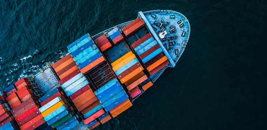 Container ship transporting cargo across international waters as part of a global sourcing and supply chain network.