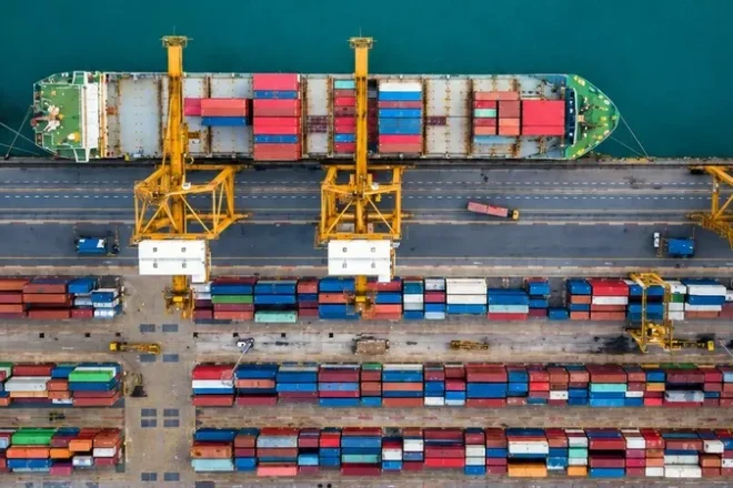 Container ship transporting cargo across international waters as part of a global sourcing and supply chain network.
