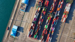 Container ship transporting cargo across international waters as part of a global sourcing and supply chain network.