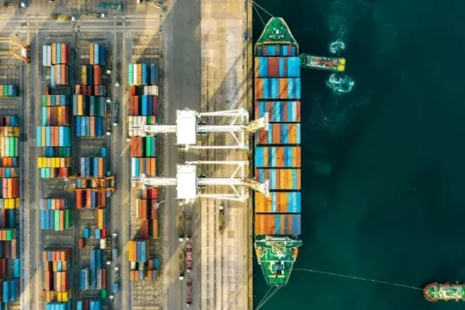 Container ship transporting cargo across international waters as part of a global sourcing and supply chain network.