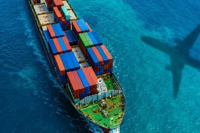 Cargo ship loaded with containers departing an international seaport.